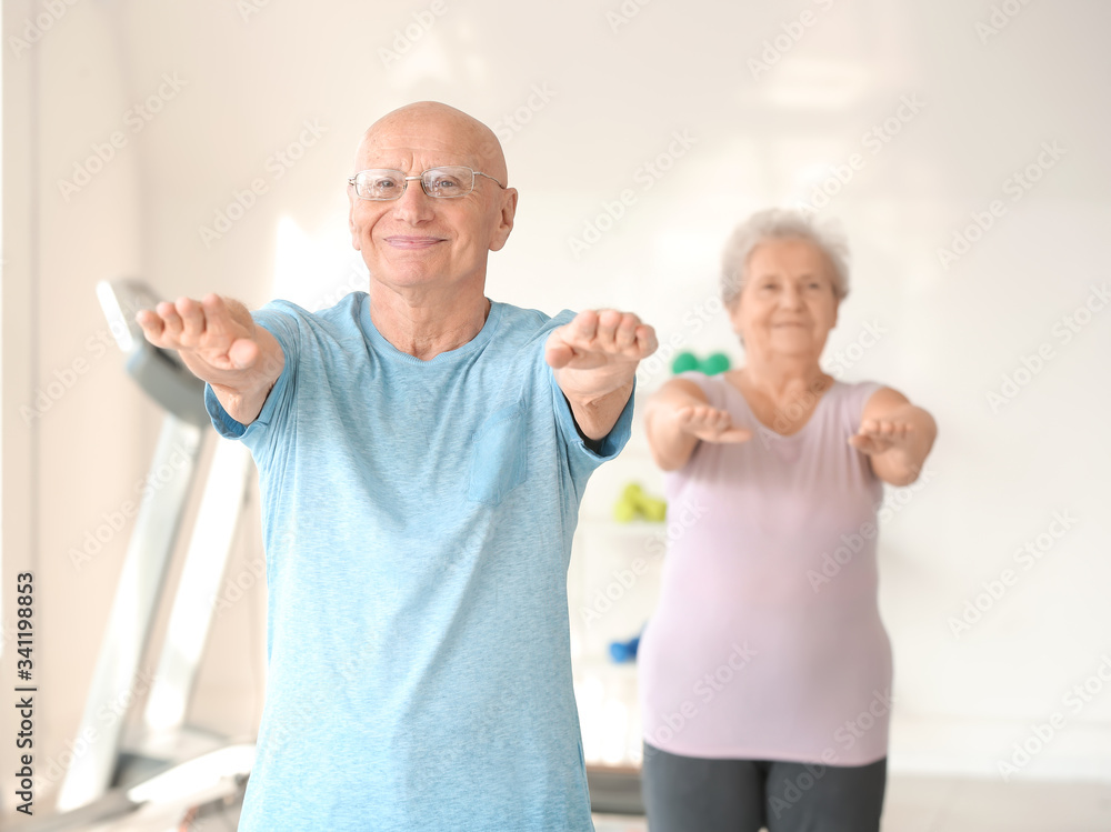 Elderly man exercising in gym