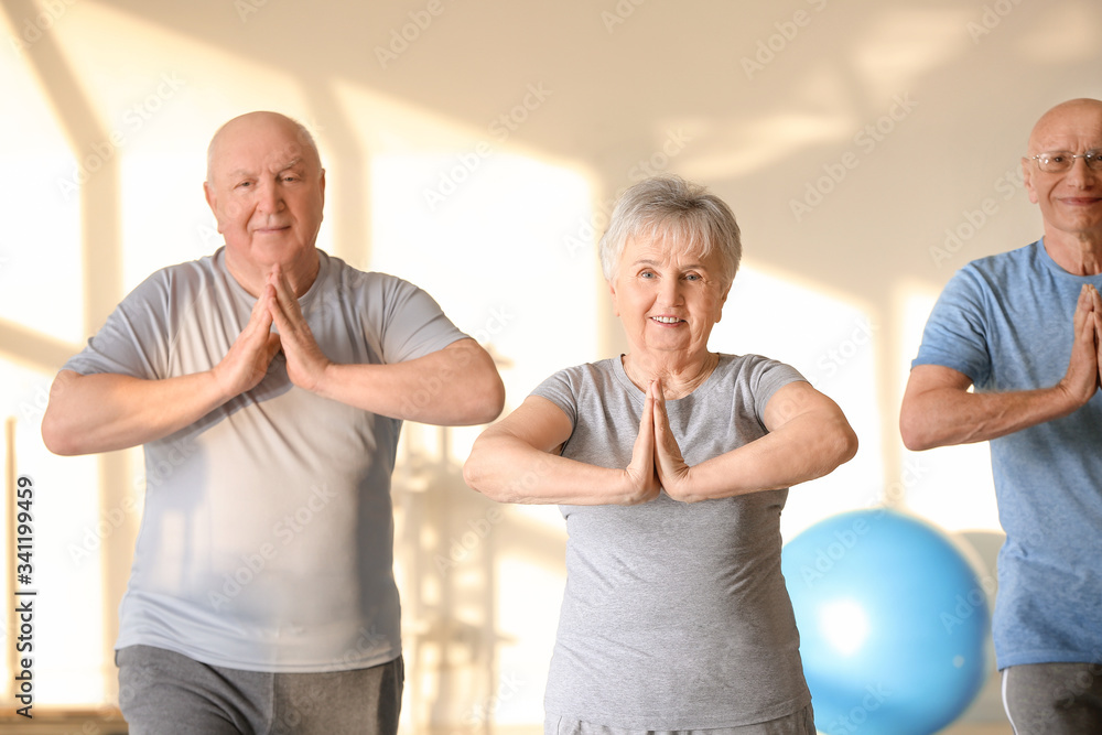 Elderly people exercising in gym