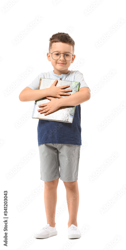 Cute little boy with book on white background