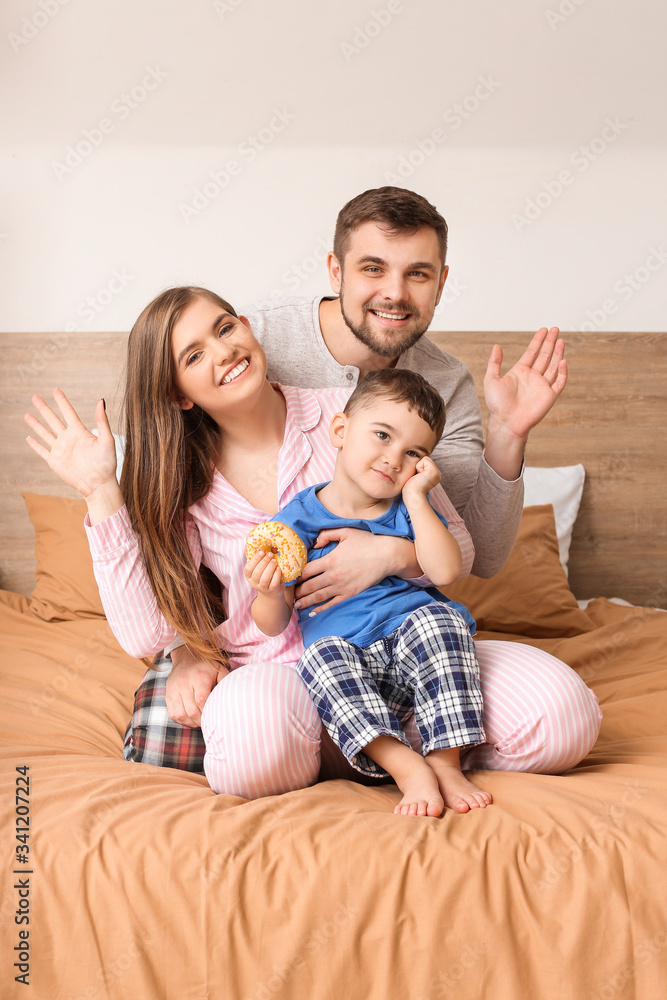 Portrait of happy family in bedroom