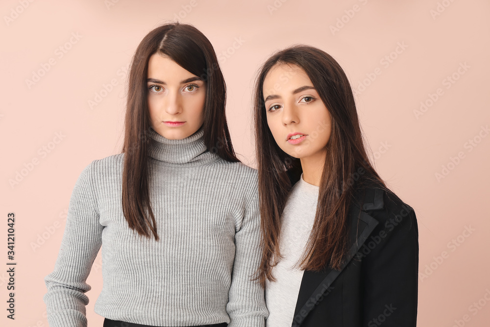 Stylish young women on color background