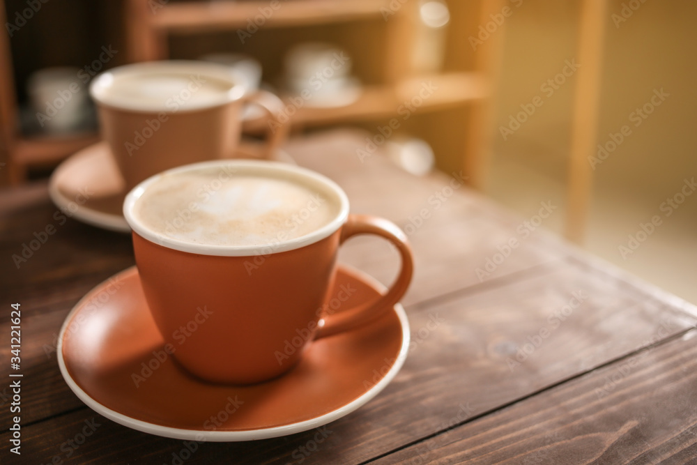 Cup of tasty cappuccino on table in cafe