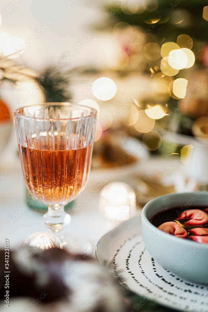 Christmas table setting with a glass of alcohol