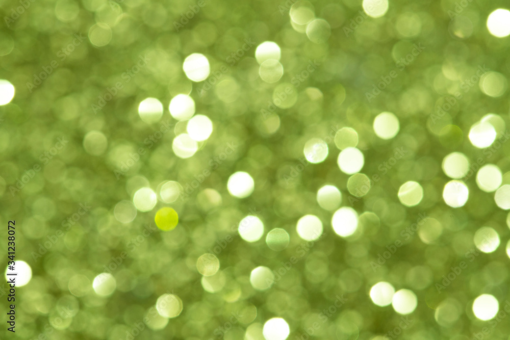 Shiny blurry green glitter textured background