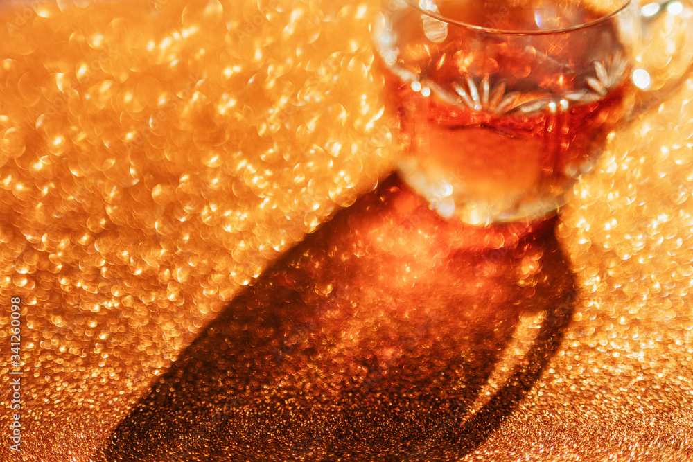 Whisky in a glass on a golden background