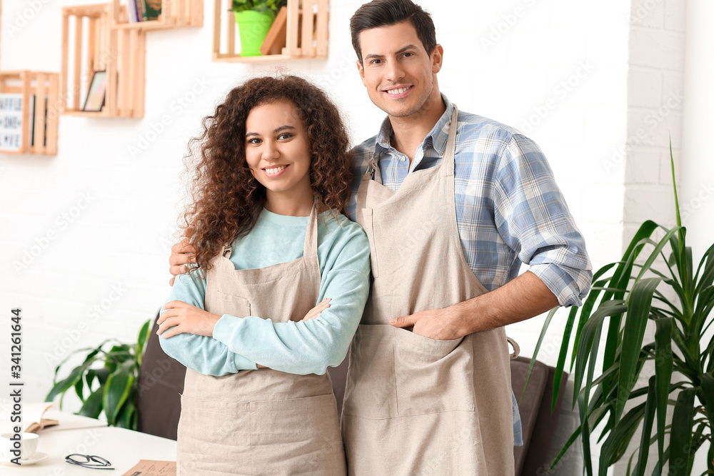 Portrait of business owners in their cafe