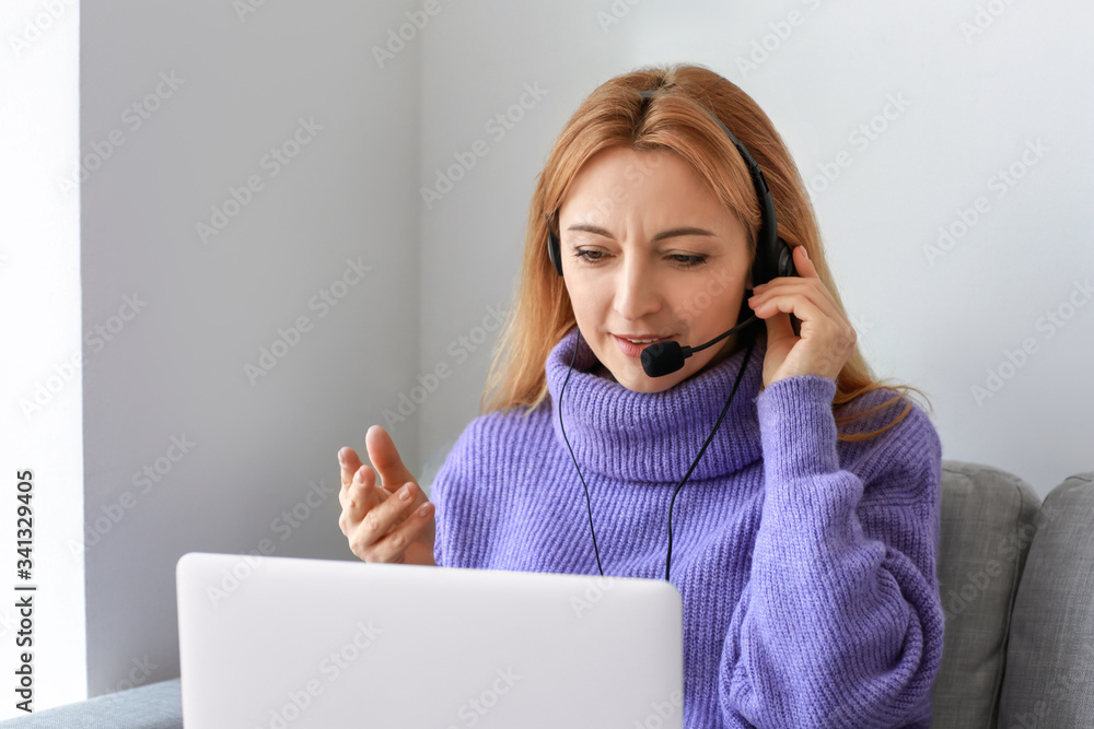 Mature woman using laptop for online learning at home