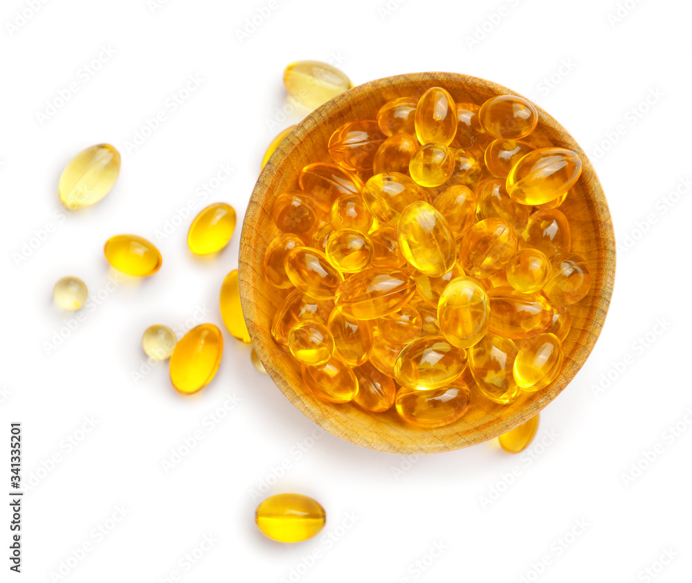 Bowl with fish oil capsules on white background