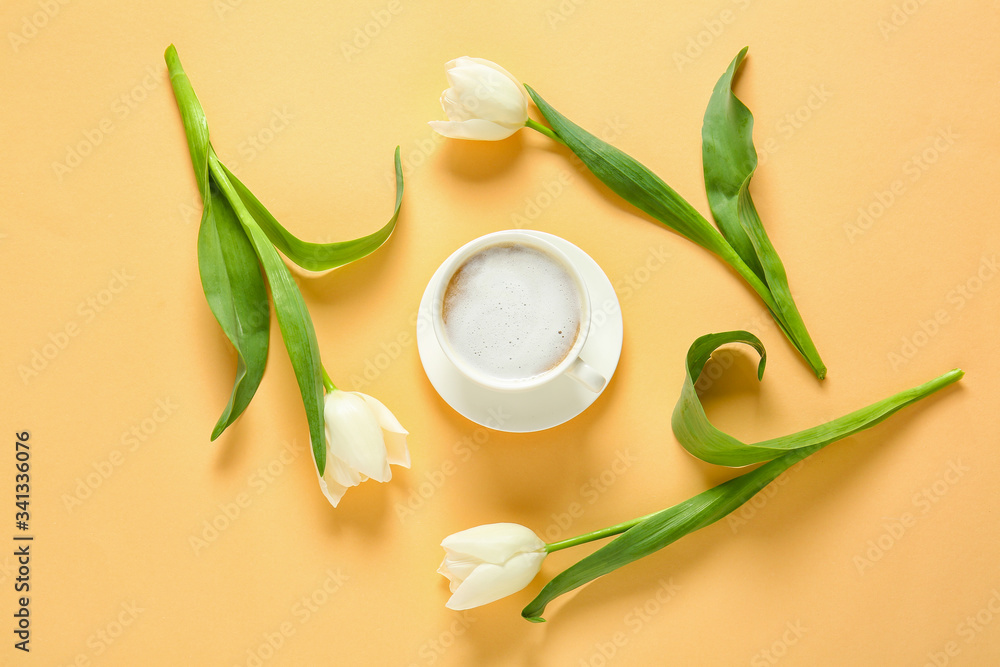 Cup of coffee and flowers on color background