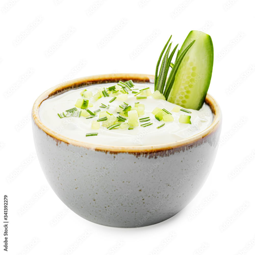 Delicious yogurt sauce with cucumber in bowl on white background