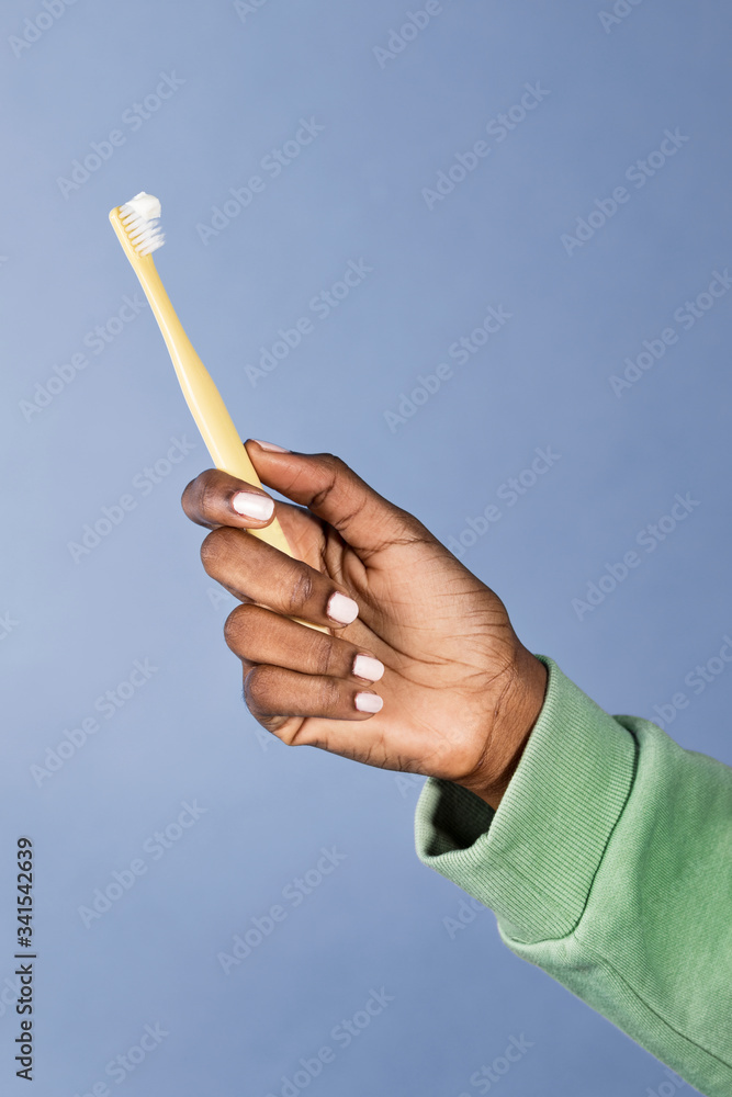 Female hand with a toothbrush