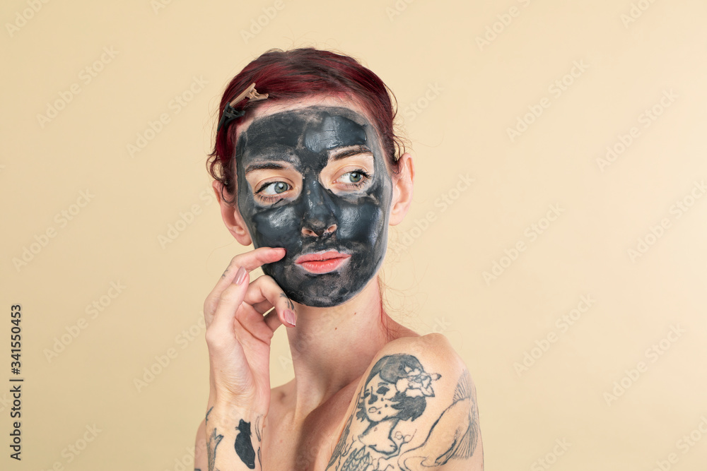 Woman doing a black charcoal mask