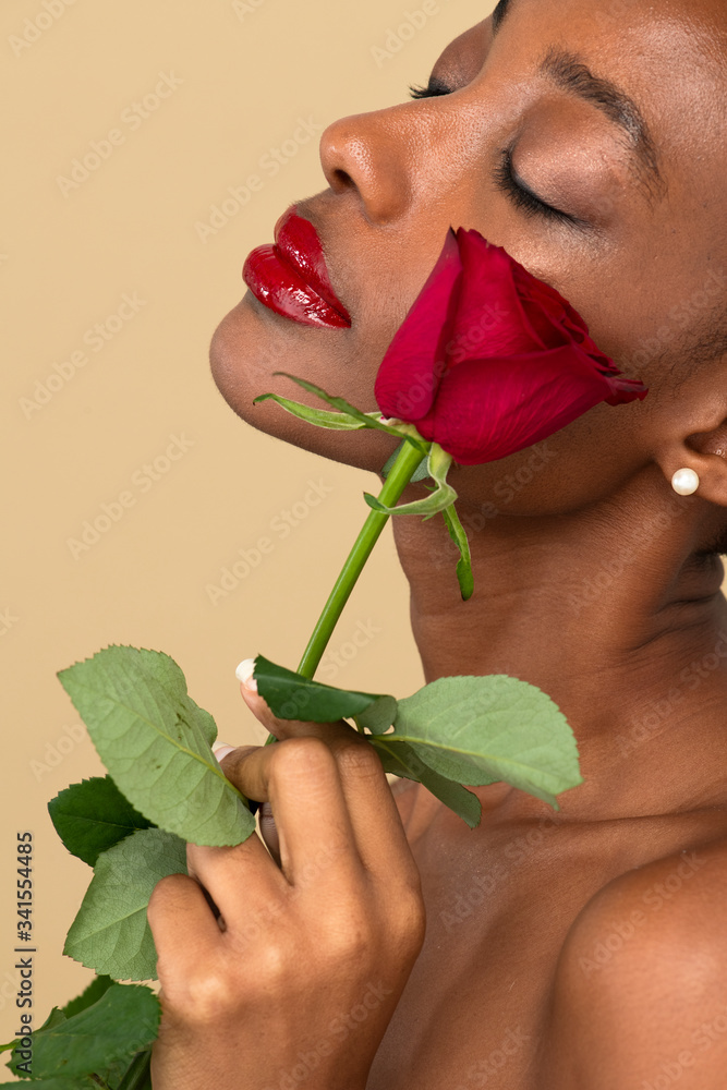 Portrait of a black woman with a red rose