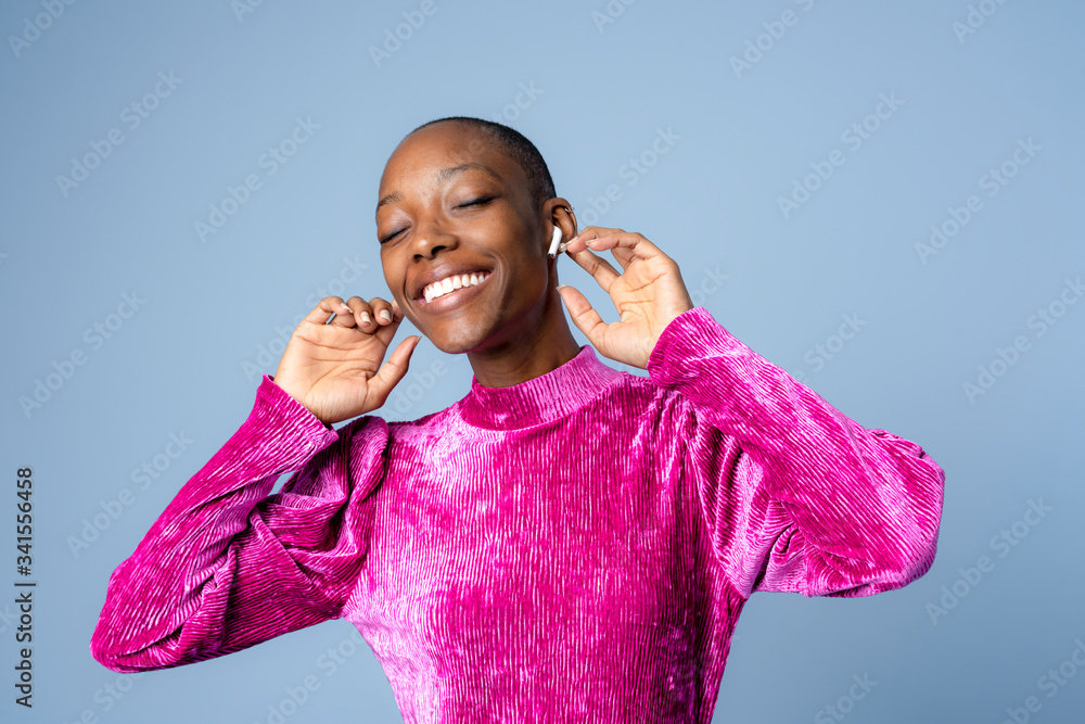 Black woman dancing with wireless earphones