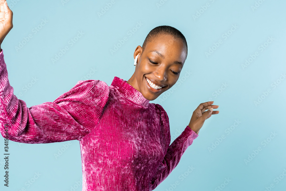 Black woman dancing with wireless earphones