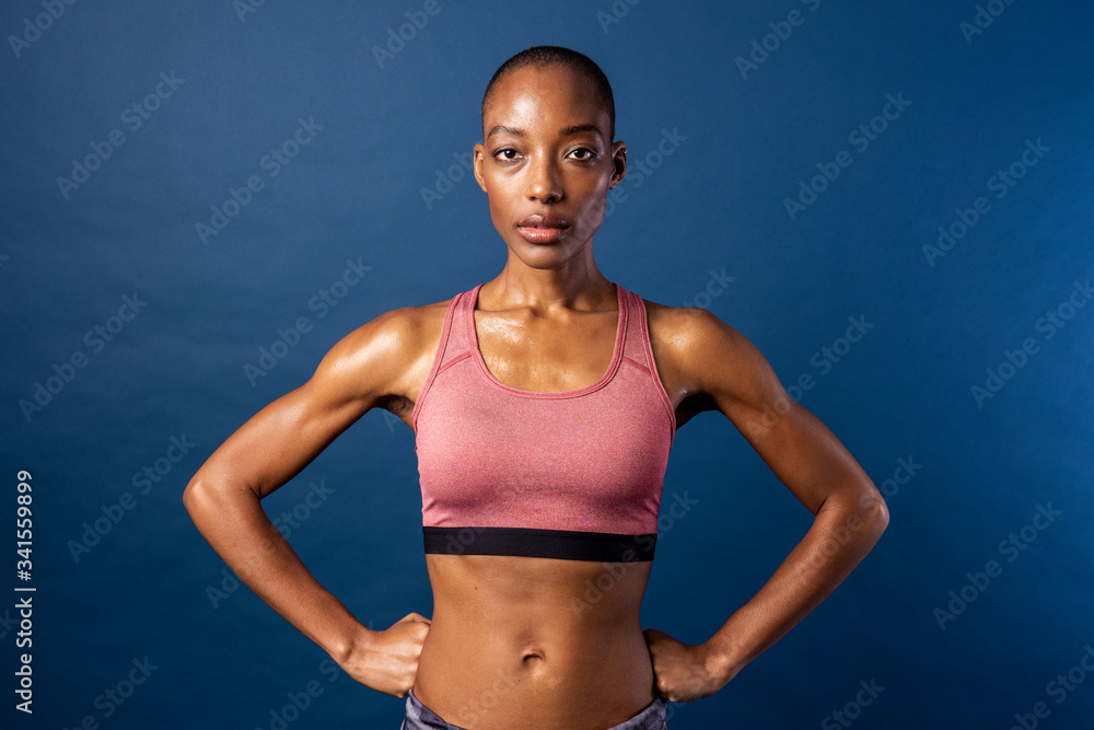 Black woman in sportswear on blue background