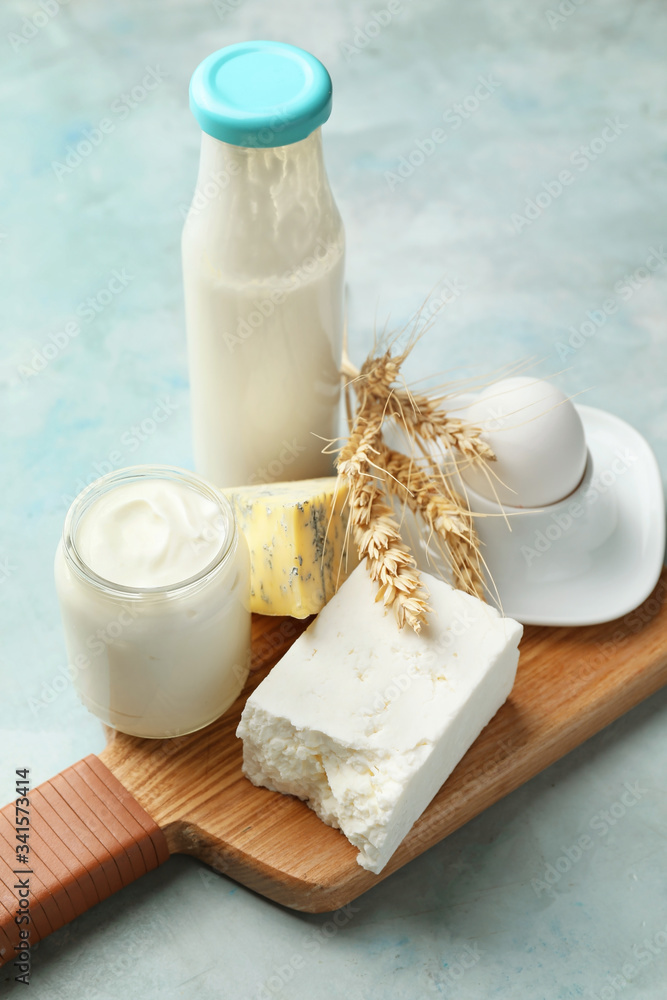 Different dairy products on color background