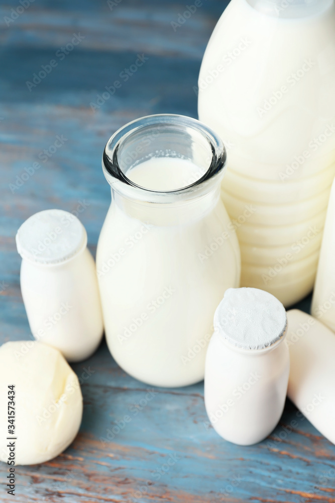 Different dairy products on color wooden background