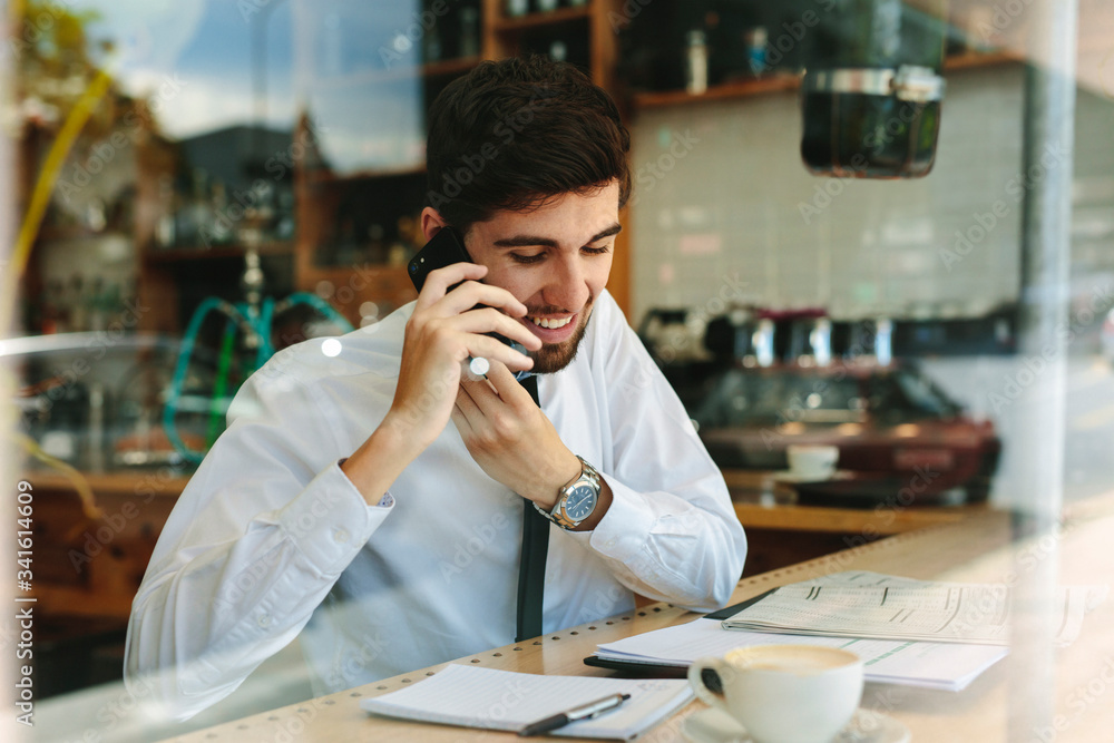 Businessman doing his work sitting at a coffee shop