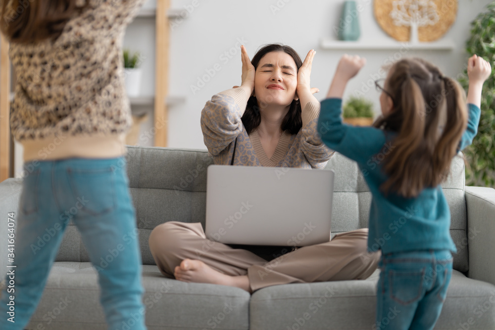 Woman working on a laptop.