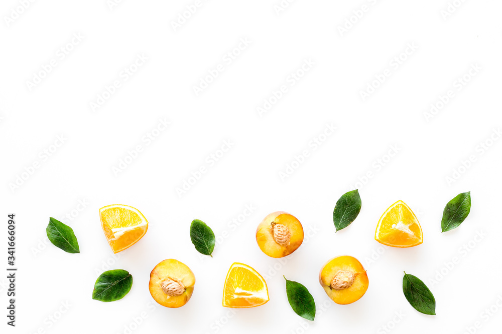 Peach slices and leaves pattern on white background top-down frame copy space