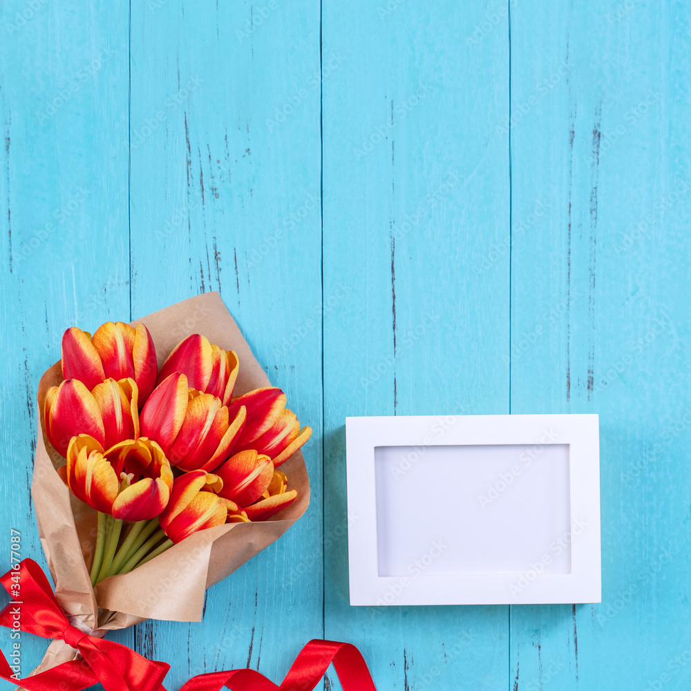 Mothers Day background, tulip flower bunch - Beautiful Red, yellow bouquet isolated on blue wooden 