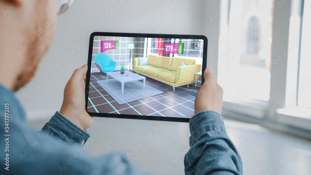 Decorating Apartment: Man Holding Digital Tablet with AR Interior Design Software Chooses 3D Furnitu