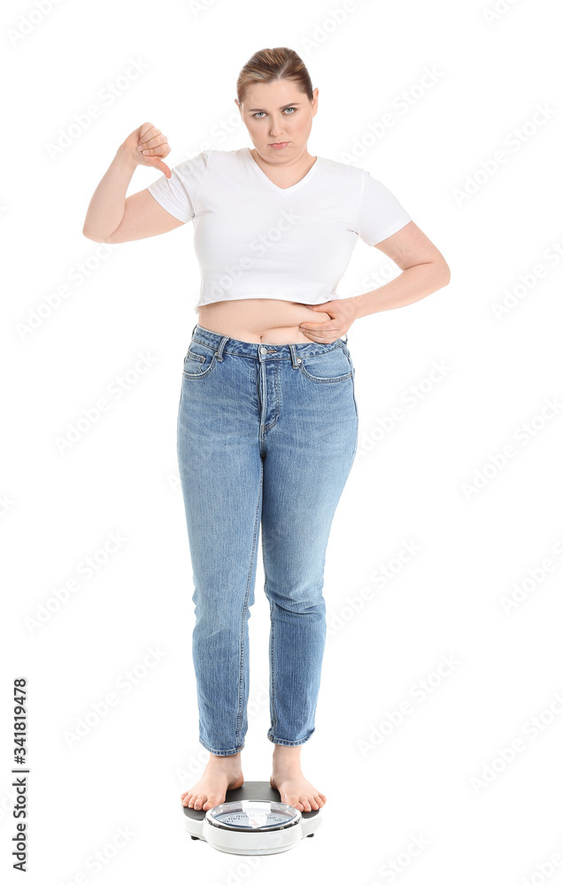 Displeased overweight woman on scales against white background. Weight loss concept