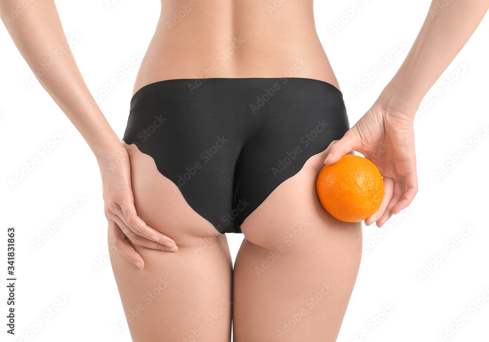 Young woman with orange fruit on white background. Concept of cellulite