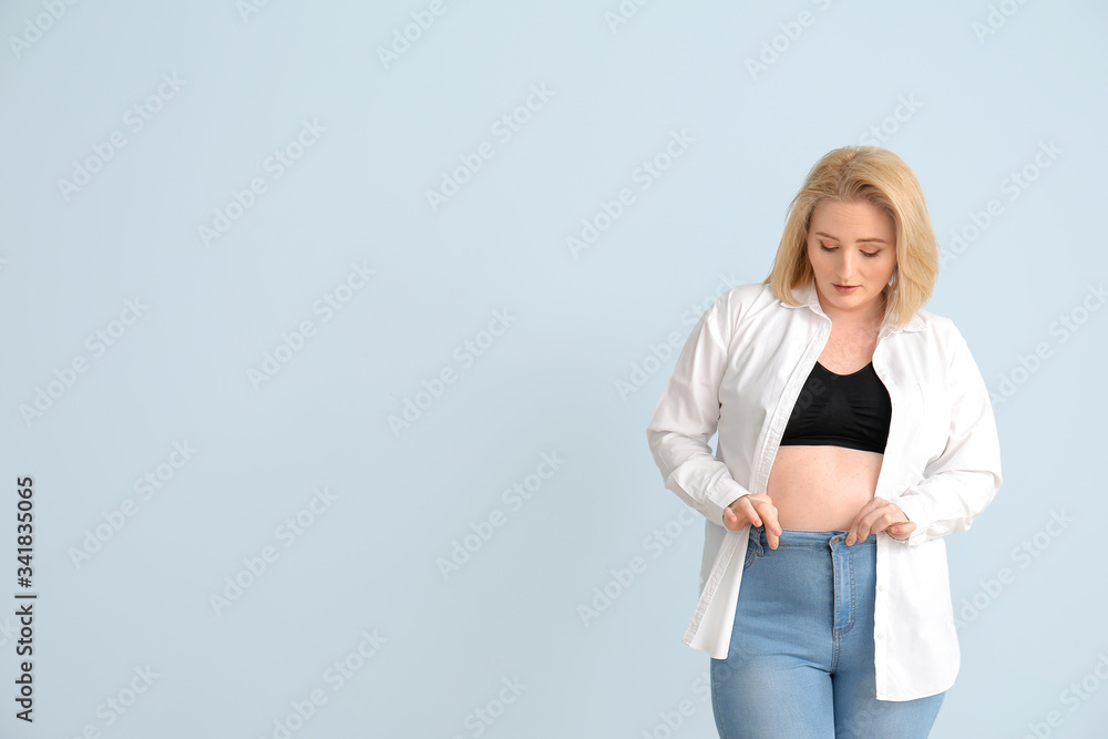 Overweight woman on color background