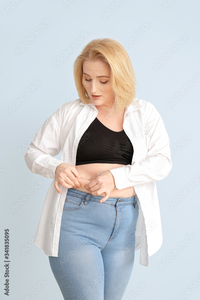 Overweight woman on color background