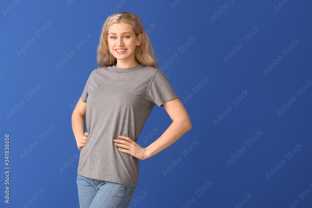 Woman in stylish t-shirt on color background