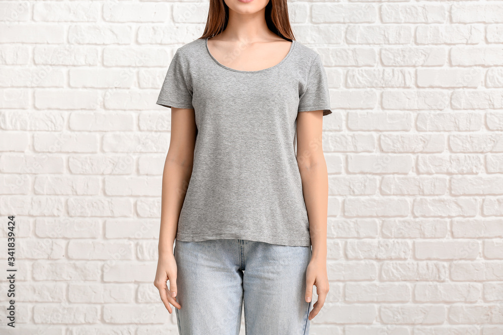 Young woman in stylish t-shirt on white background