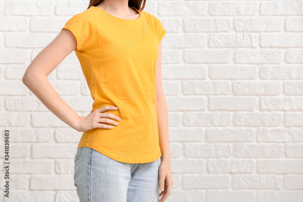 Young woman in stylish t-shirt on white background