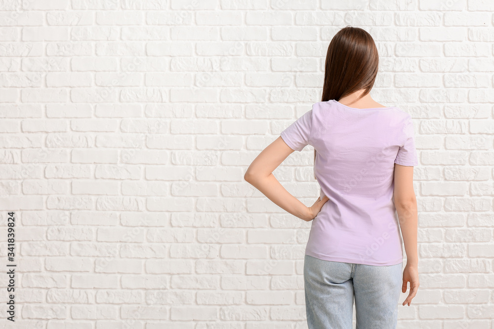 Young woman in stylish t-shirt on white background