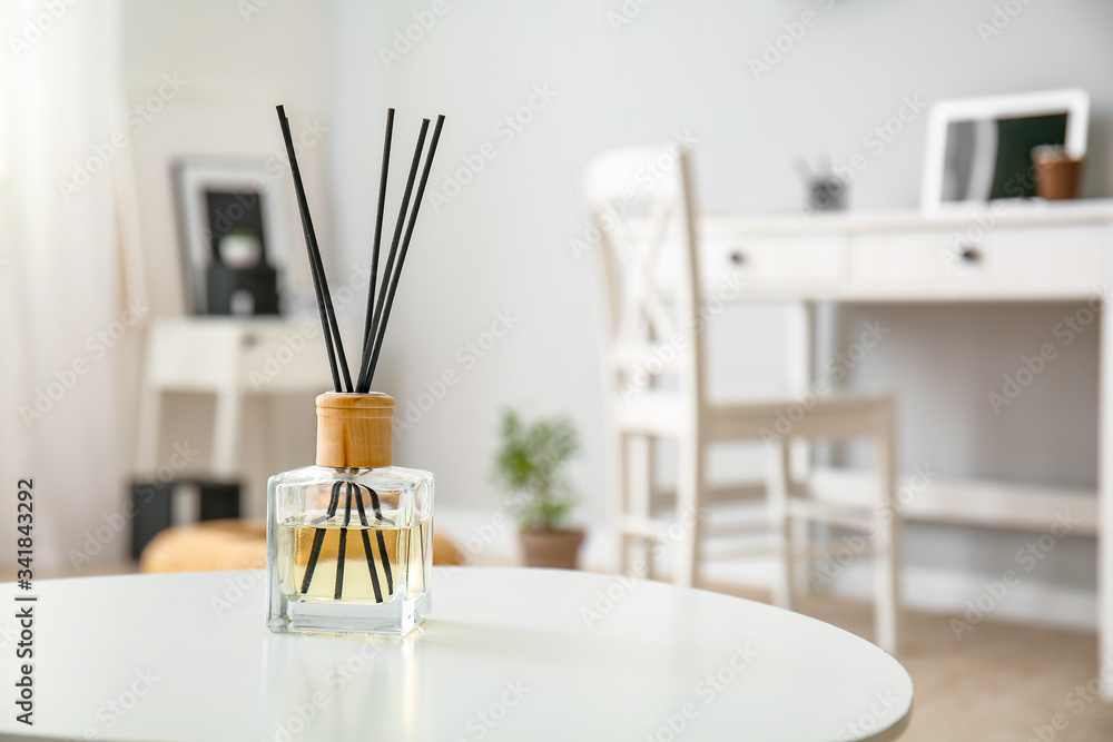 Reed diffuser on table in room