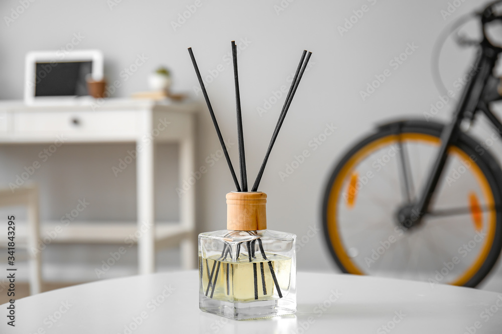 Reed diffuser on table in room