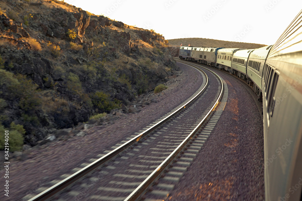 Passenger train traveling into the Arizona sunset