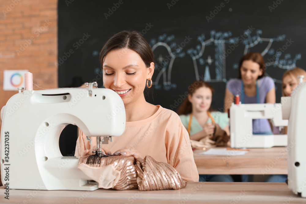 Young woman during tailors class in atelier