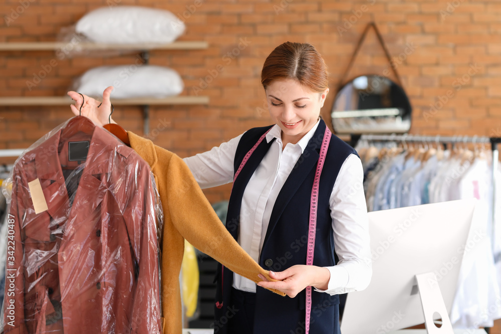 Worker of modern dry-cleaners at reception