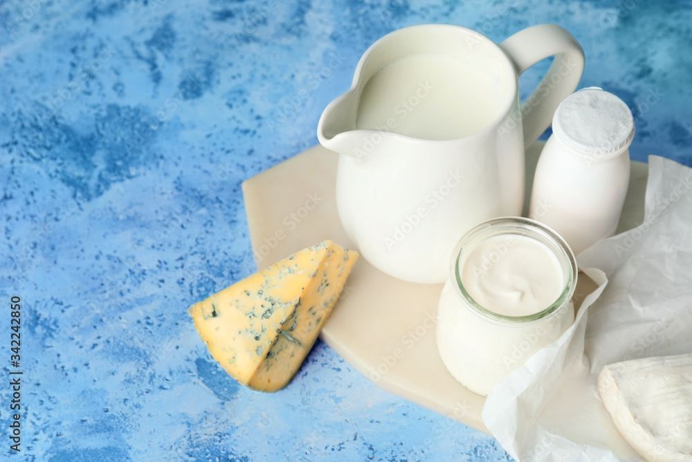 Different dairy products on color background