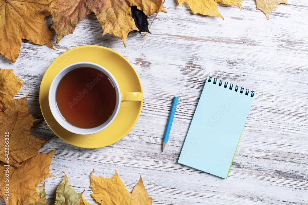 Flat lay autumn composition with cup of black tea