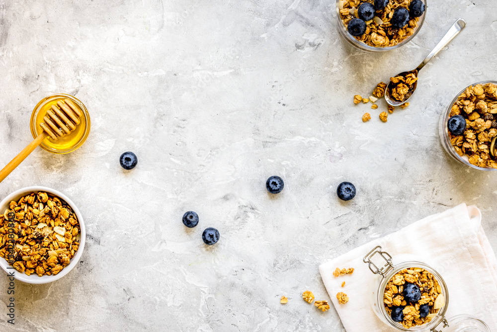 Oat flakes and berries granola glass on table background top view