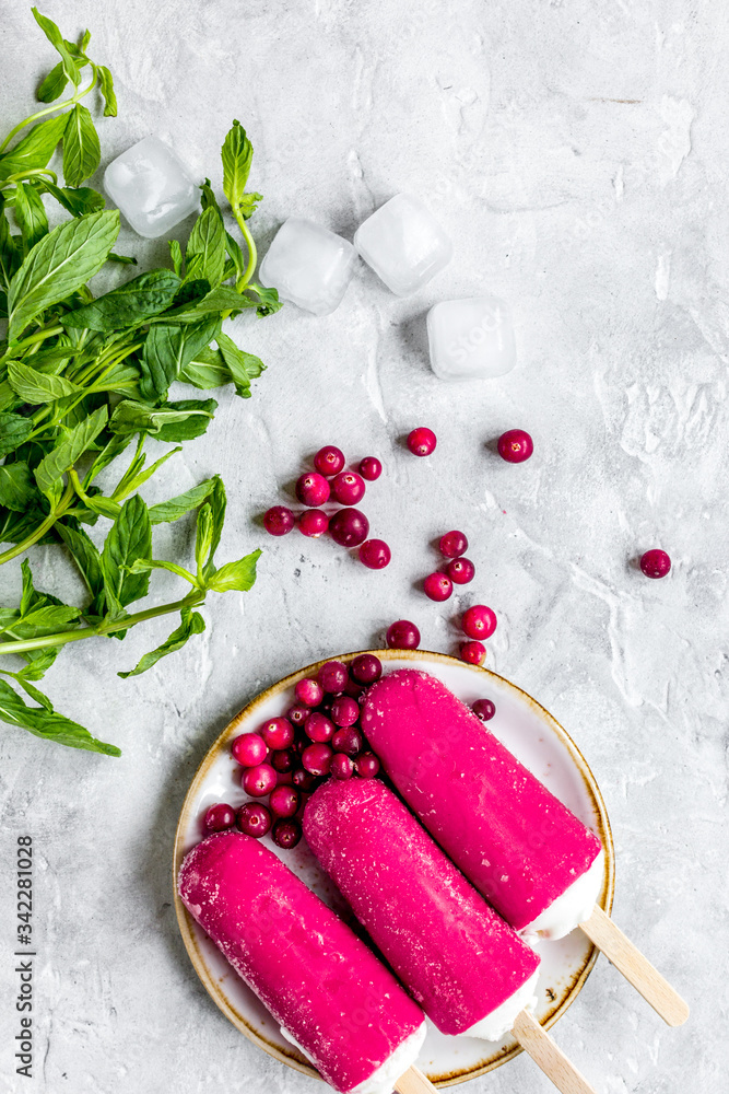 summer dessert with popsicle and red berries stone desk background top view