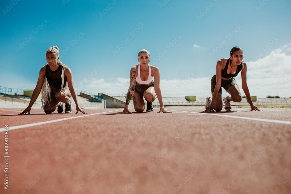 Sprinters at starting blocks ready for race