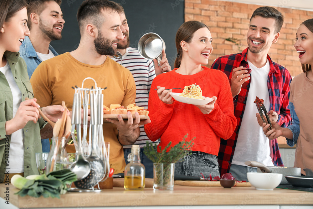 Young friends cooking together at home