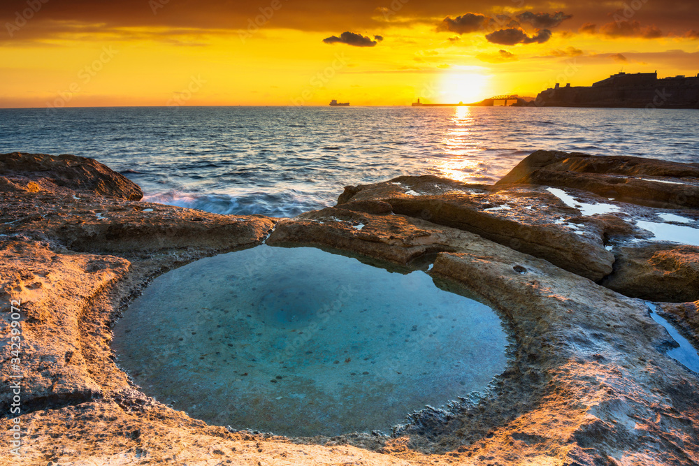 Amazing landscape of the rocky coast in Malta at sunrise.