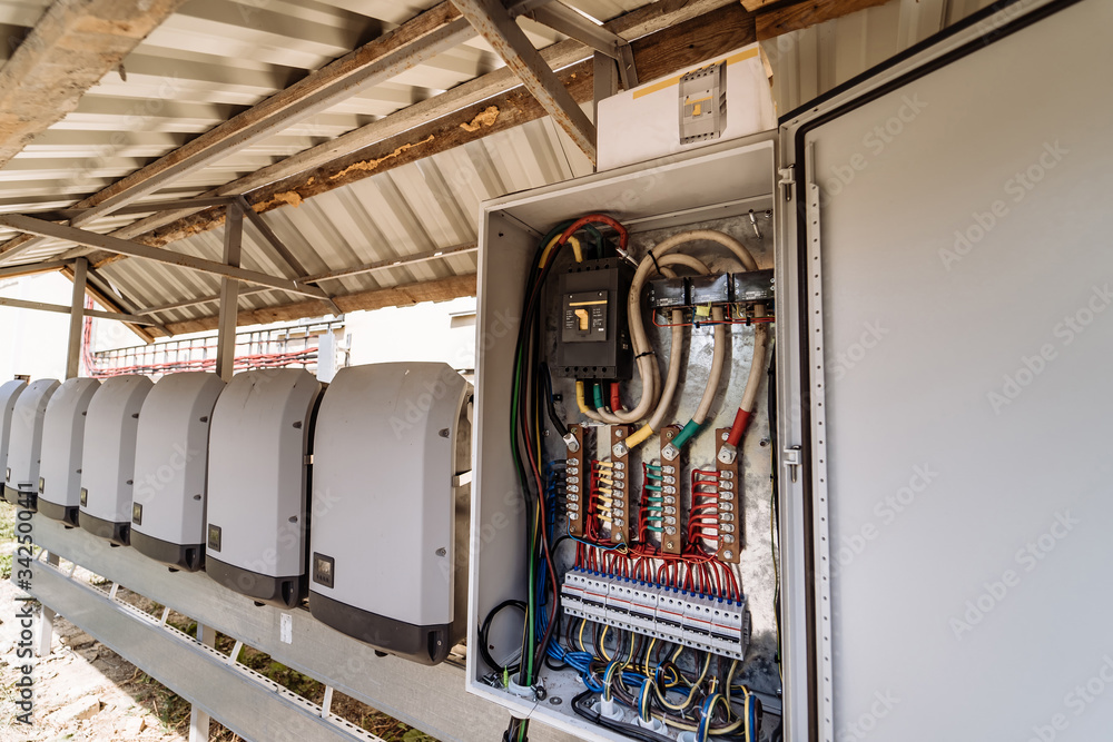 Electrical panel at a assembly line factory. Controls and switches. Color wires in a box of distribu