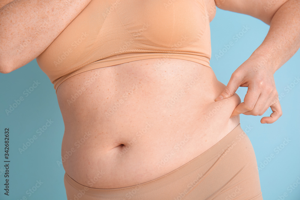 Overweight woman on color background, closeup