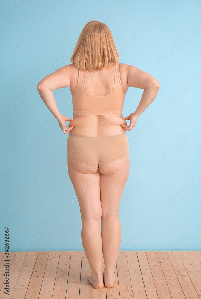 Overweight woman on color background